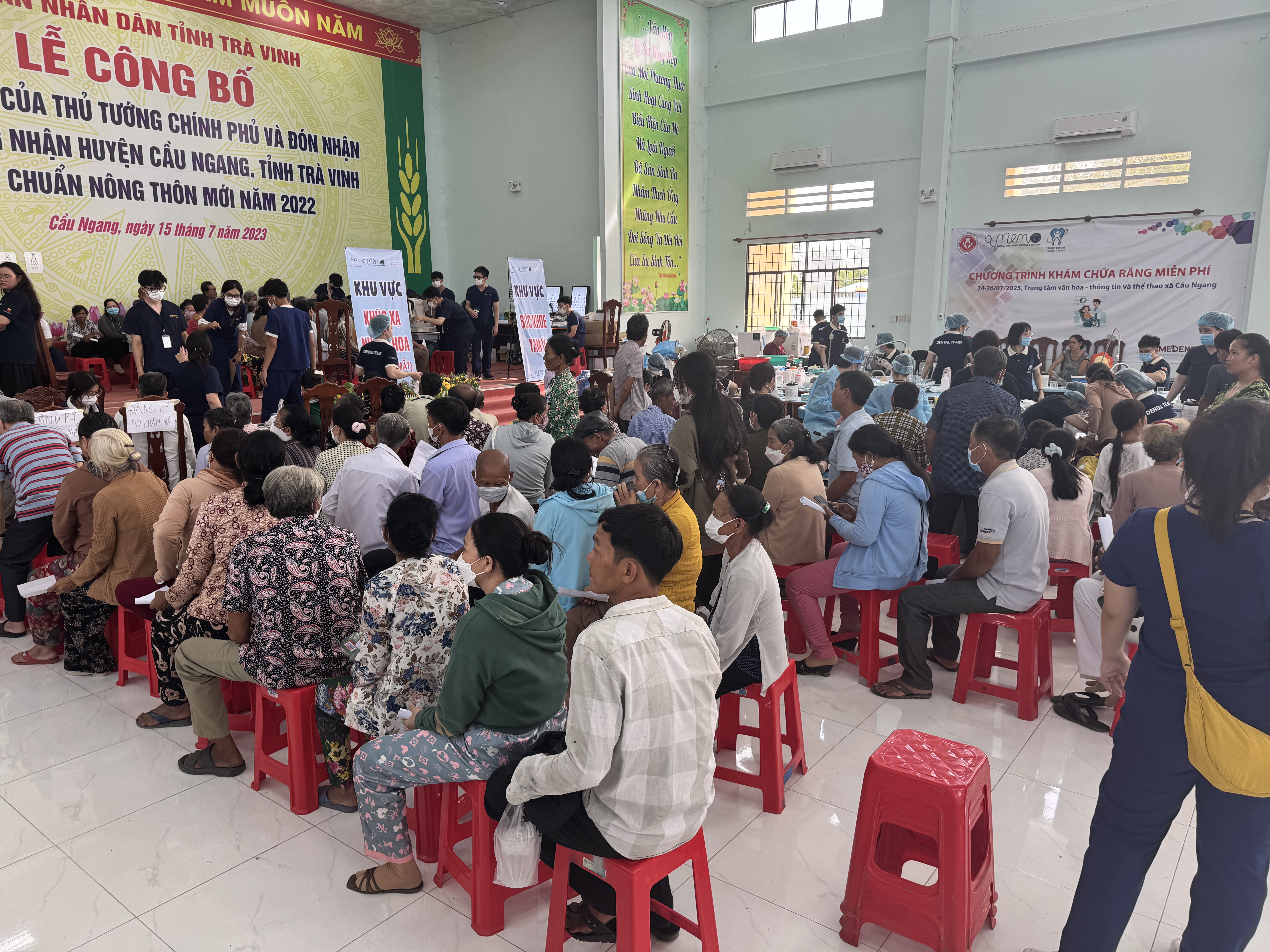 Large group of patients gathered inside a community clinic space